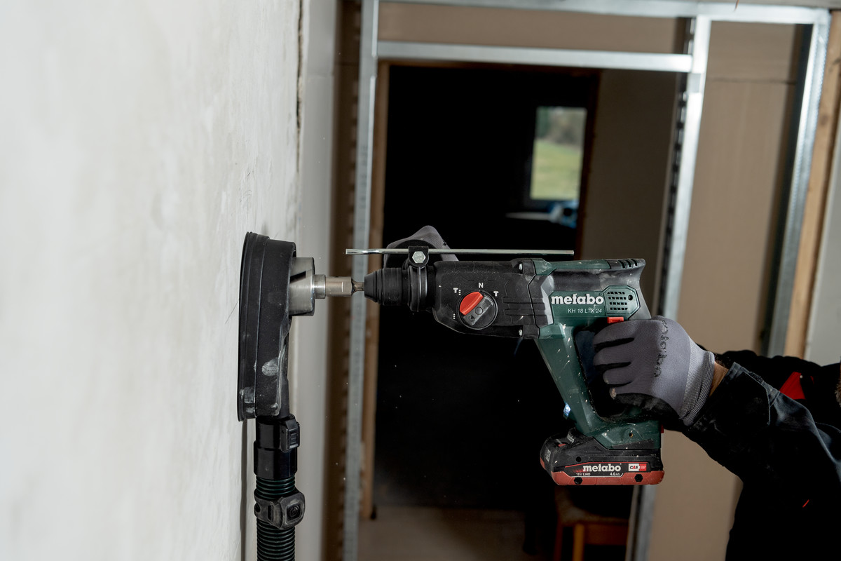 Akumulatorowa młotowiertarka 2.1J SDS-plus METABO KH 18 LTX 24 601712850 podczas wiercenia w betonie